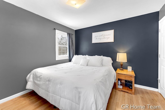 bedroom with wood finished floors and baseboards