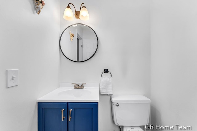 bathroom featuring vanity and toilet