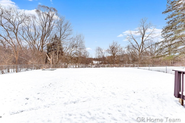 snowy yard with fence