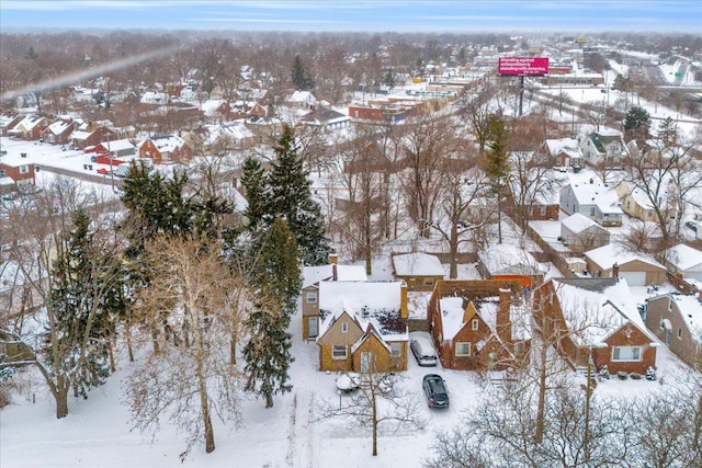 snowy aerial view with a residential view