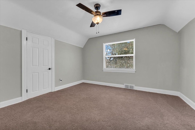 additional living space with lofted ceiling, carpet flooring, visible vents, and baseboards