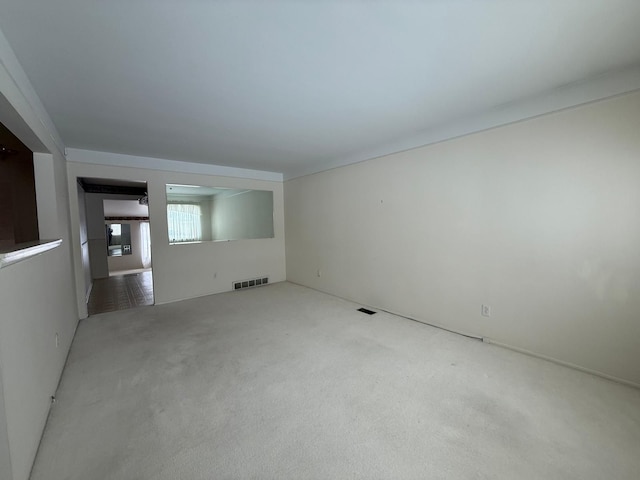 carpeted spare room with visible vents