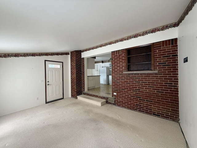 interior space featuring brick wall and carpet