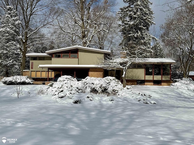 view of front of property with a sunroom and brick siding