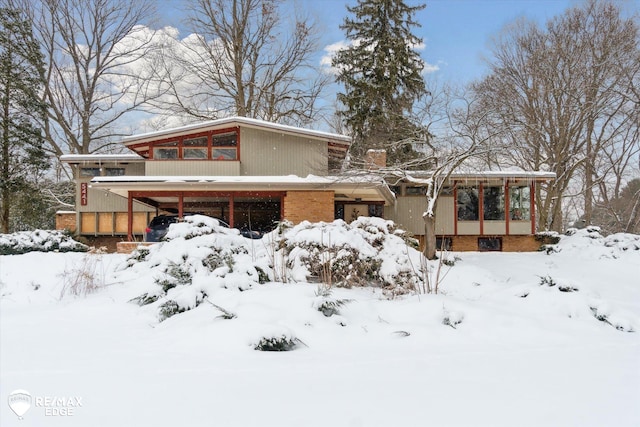 view of front of home featuring a garage and brick siding