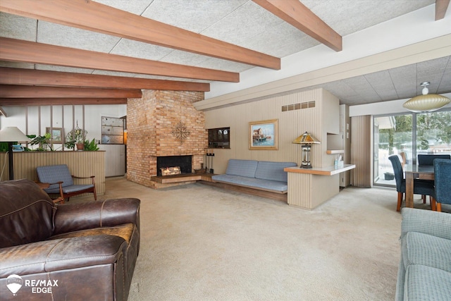 living area featuring a brick fireplace, light carpet, visible vents, and beam ceiling