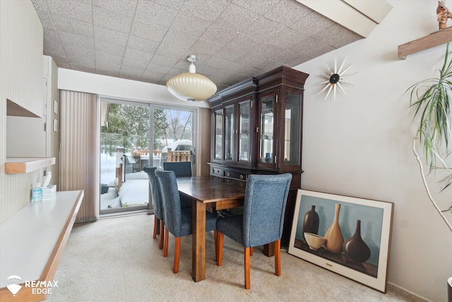 dining room featuring light carpet