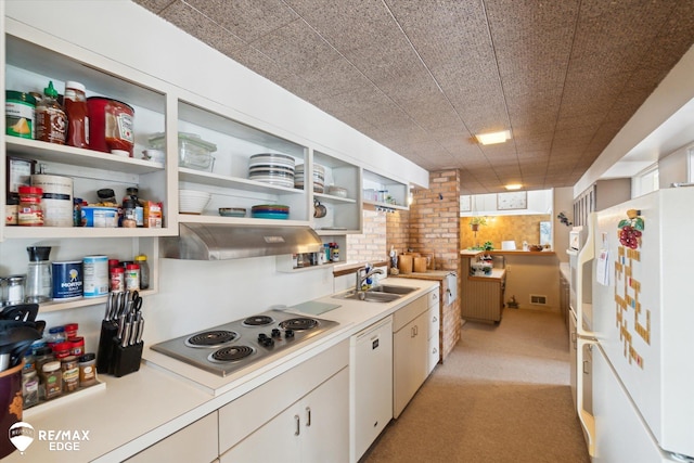 kitchen with white appliances, white cabinets, range hood, open shelves, and a sink