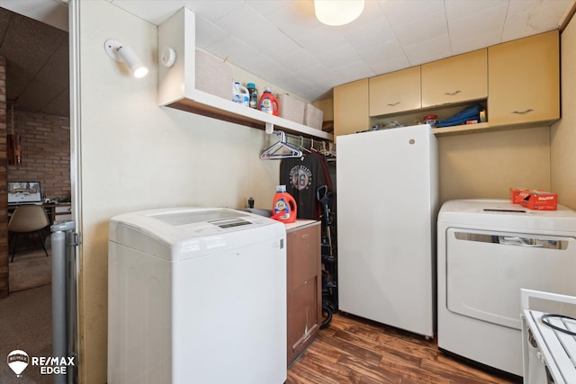 clothes washing area with laundry area, washer and clothes dryer, and dark wood-type flooring