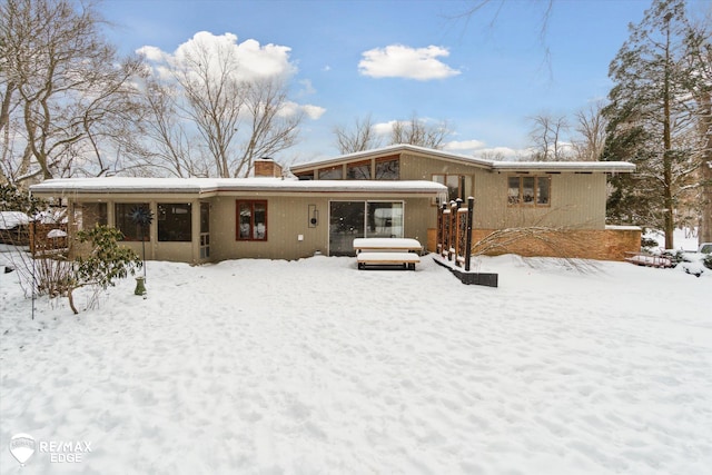 snow covered house with a chimney