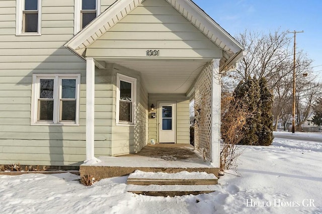 view of snow covered property entrance