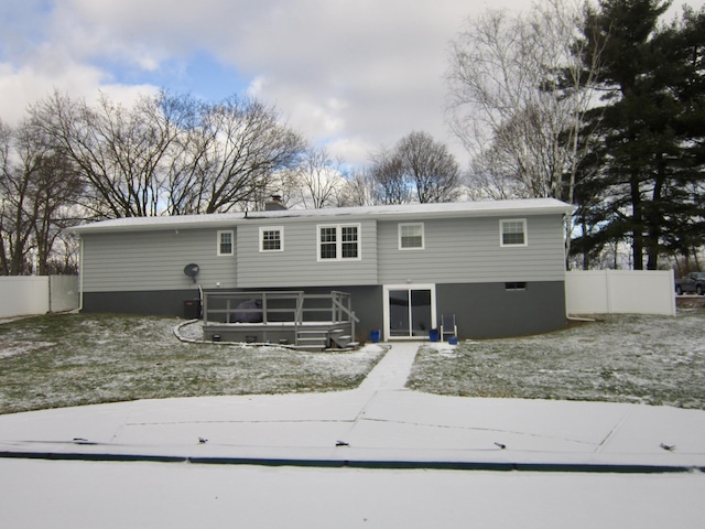 rear view of property featuring fence