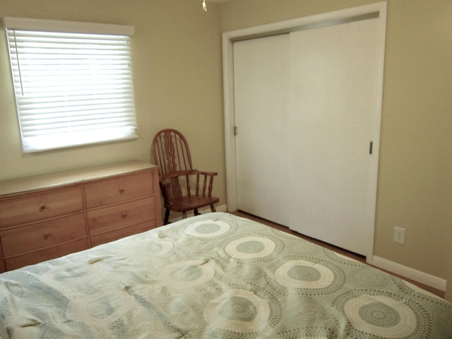 unfurnished bedroom with a closet and baseboards