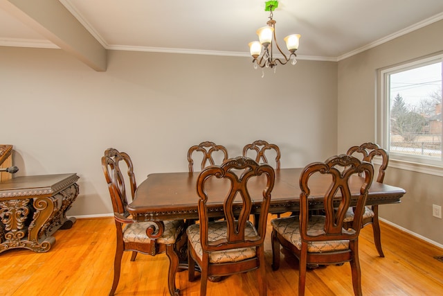 dining space with crown molding, light wood-style floors, baseboards, and an inviting chandelier