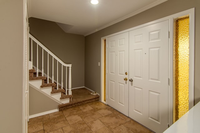 foyer with stairs, crown molding, and baseboards