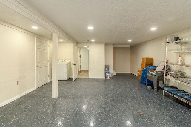 finished basement with a textured ceiling, recessed lighting, washer / dryer, and baseboards