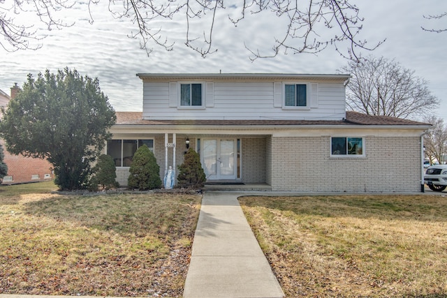 traditional-style house with brick siding and a front yard