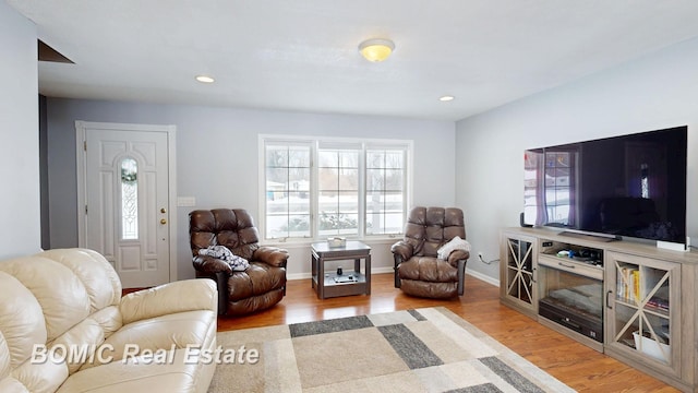 living room with baseboards, wood finished floors, and recessed lighting