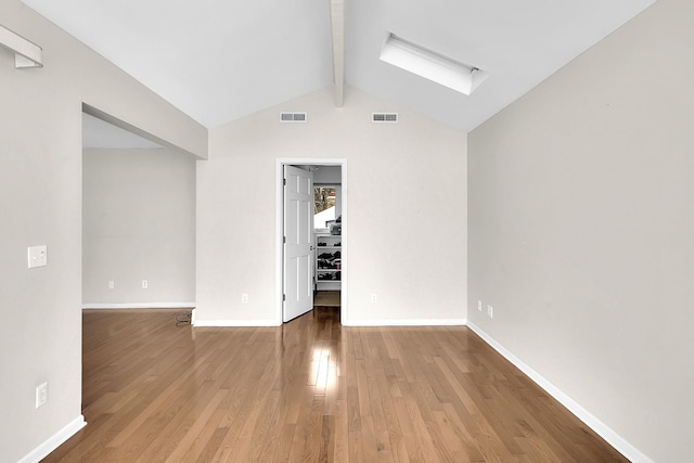 spare room with visible vents, baseboards, and wood finished floors