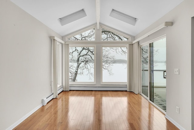 doorway with lofted ceiling with beams, light wood finished floors, baseboard heating, and baseboards