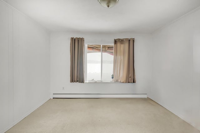 empty room featuring a baseboard radiator and light colored carpet