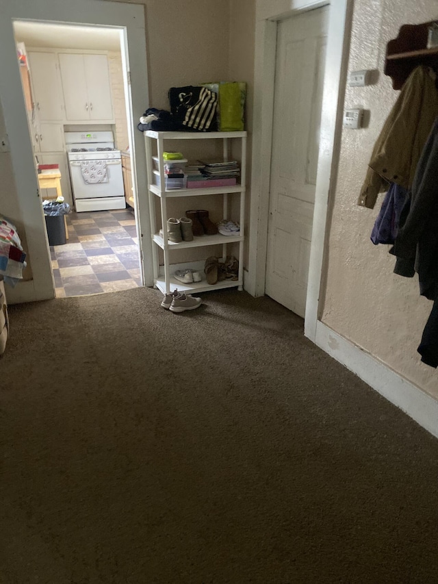 corridor with carpet floors and tile patterned floors