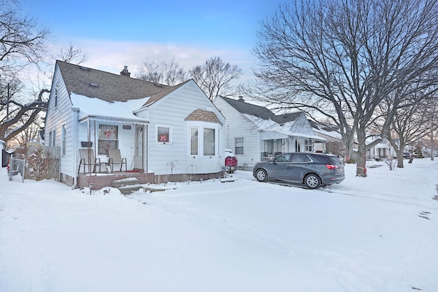 bungalow-style home with a shingled roof