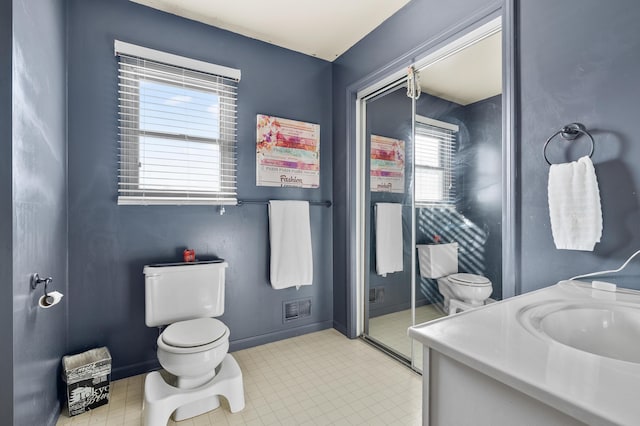 full bath with visible vents, toilet, a stall shower, vanity, and baseboards