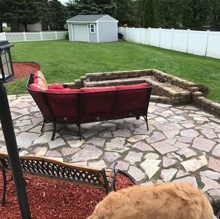 view of patio / terrace with a shed, an outdoor living space, a fenced backyard, and an outbuilding