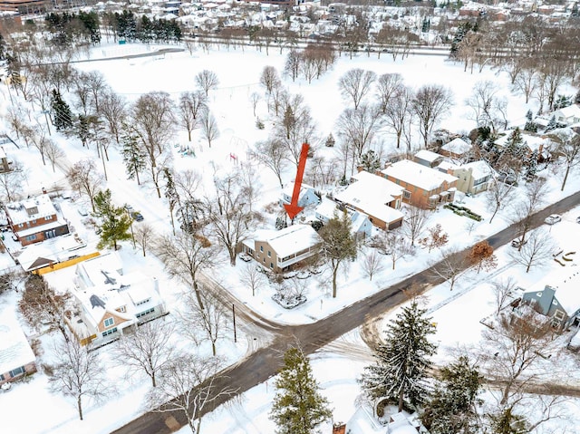 snowy aerial view featuring a residential view