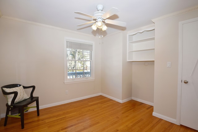 interior space with light wood finished floors, baseboards, and a ceiling fan