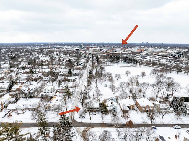 snowy aerial view with a residential view