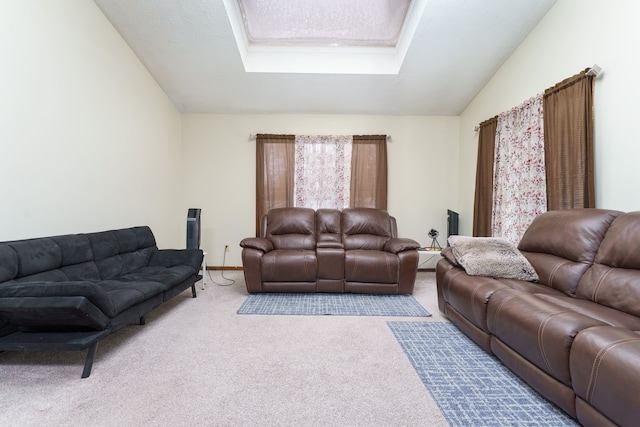 carpeted living room with lofted ceiling with skylight and a textured ceiling