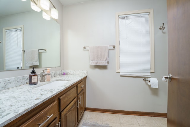 bathroom featuring tile patterned flooring, vanity, and baseboards