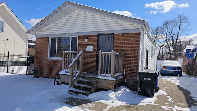 view of front of home with fence and brick siding