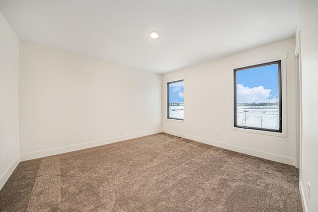 empty room with carpet and baseboards