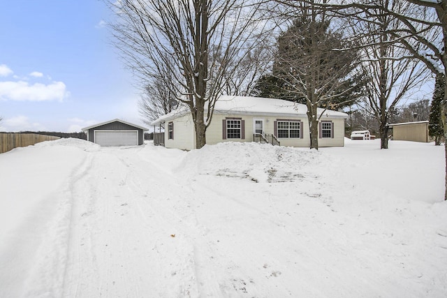 ranch-style house featuring a garage and an outbuilding