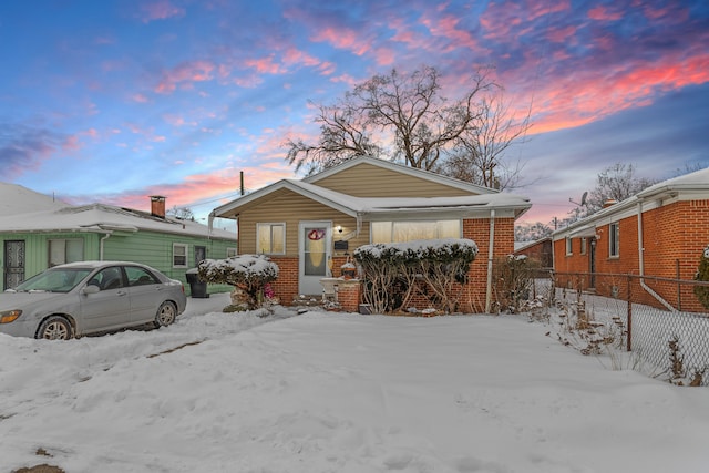 view of front of property featuring brick siding and fence