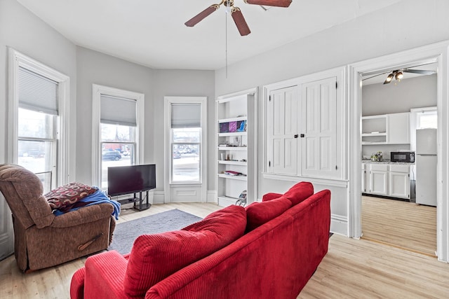 living area featuring ceiling fan and light wood-style floors