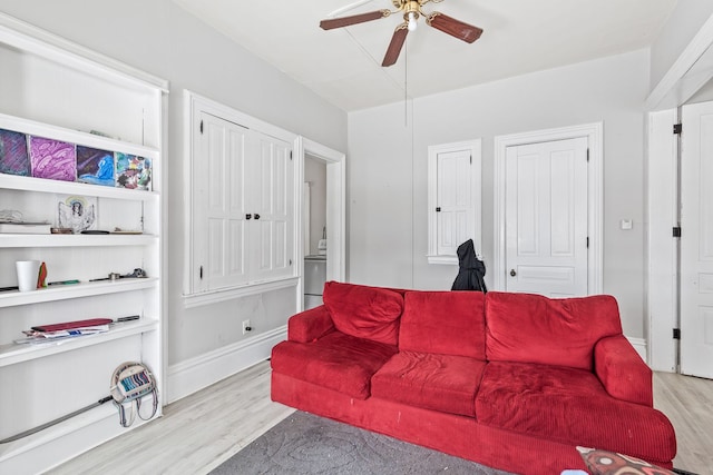 living area featuring light wood-style floors, ceiling fan, and baseboards