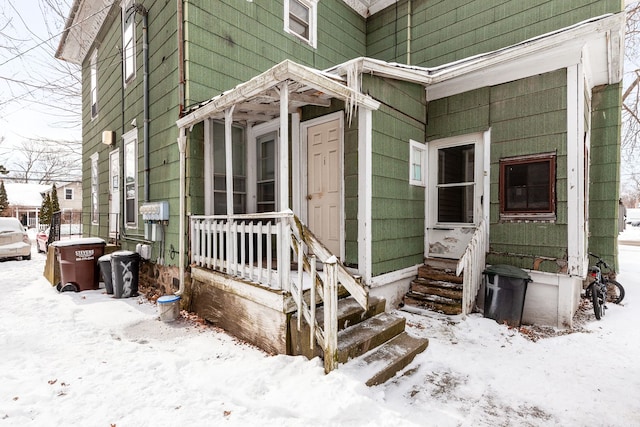 view of snow covered property entrance