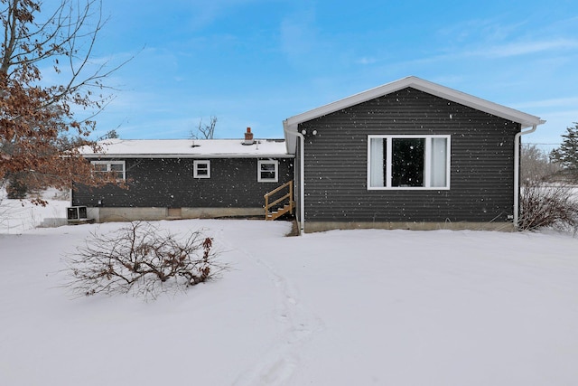 snow covered property with cooling unit