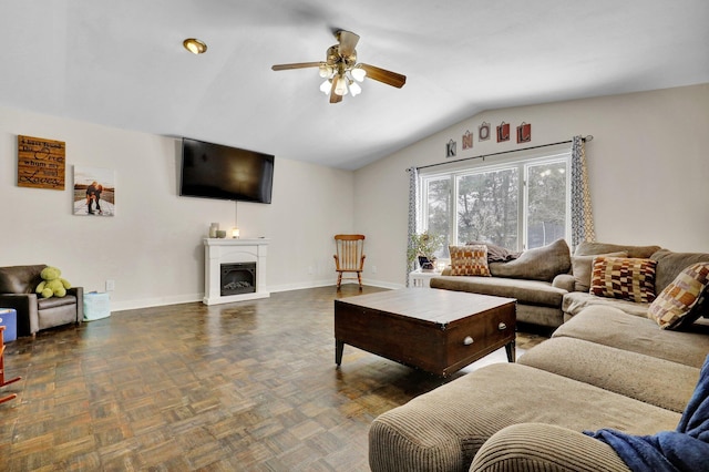 living area with lofted ceiling, a fireplace, a ceiling fan, and baseboards