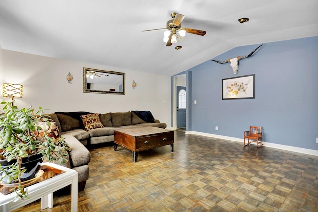 living room with lofted ceiling, ceiling fan, and baseboards