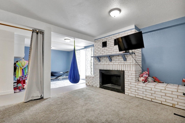 living room featuring a brick fireplace, carpet, and a textured ceiling