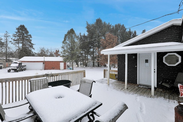 snow covered deck with outdoor dining space