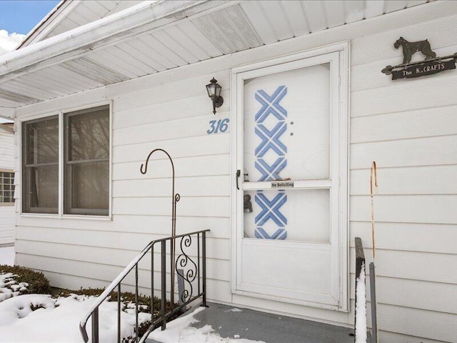 view of snow covered property entrance