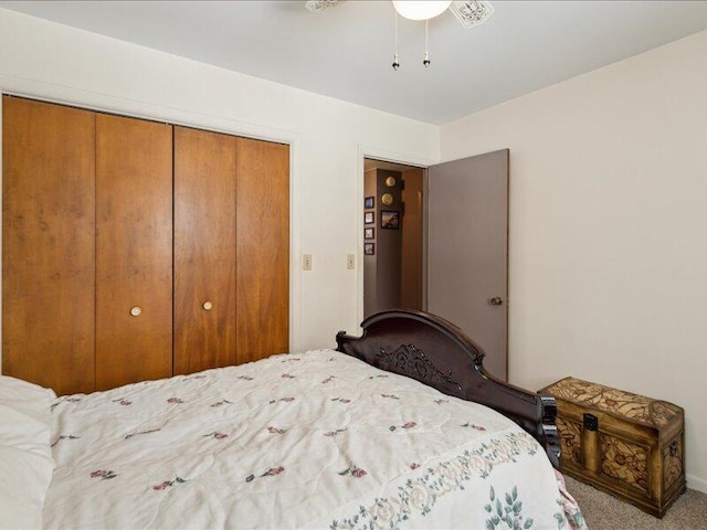 carpeted bedroom with a ceiling fan and a closet