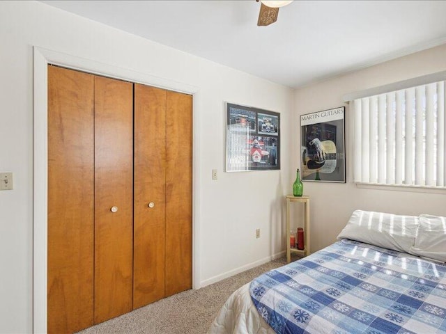 bedroom with ceiling fan, carpet floors, a closet, and baseboards