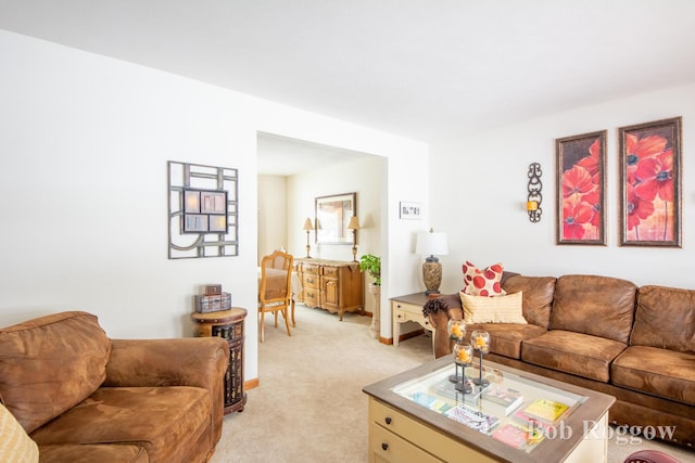 living room with light carpet and baseboards